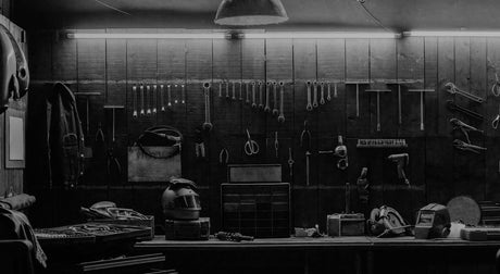 Translation missing: en.A black and white photo of a workshop wall displaying various tools and equipment