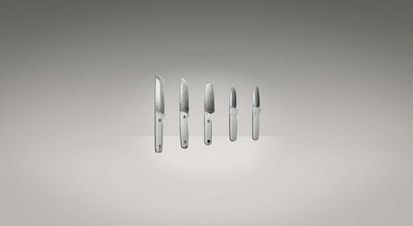 Translation missing: en.Leatherman Knives the full collection suspended in space infront of a grey background. The knives are arranged from largest to smallest. 