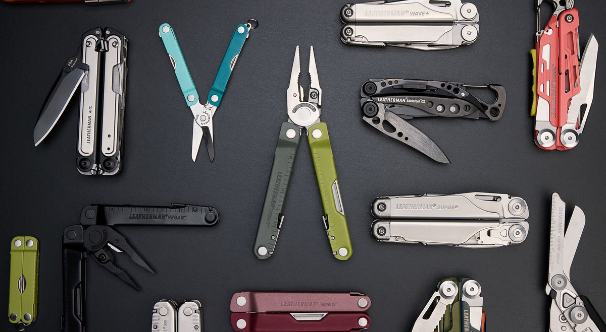 Various Leatherman tools arranged on a black surface.