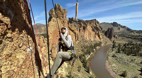 Translation missing: en.Rock climber at Smith Rock State Park with scenic cliffs and river backdrop in Central Oregon