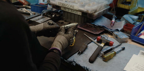 Translation missing: en.A person from Leatherman's Warranty department fixing a Stainless Steel Leatherman Skeletool® in a workshop