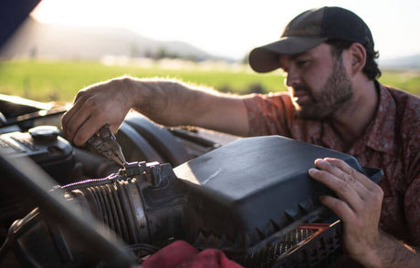 Translation missing: en.Man using a Stainless Steel Leatherman Surge® while working on an air intake