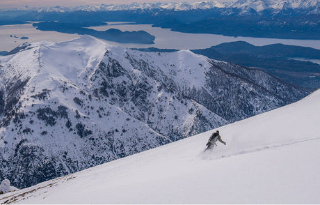 Translation missing: en.Snowboarder enjoying winter sports in fresh snow on a bright day, showcasing excitement and adventure