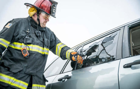 Translation missing: en.Firefighter breaking car window using a Leatherman Raptor® Rescue to rescue trapped passenger