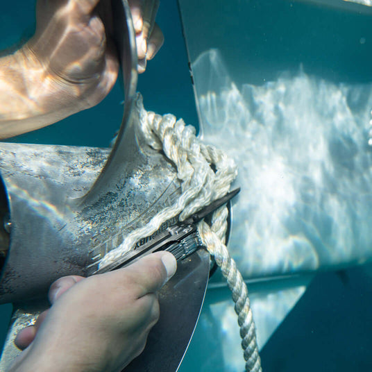 Translation missing: en.User cutting rope underwater with a Black DLC &amp; Stainless Steel Leatherman ARC® tool