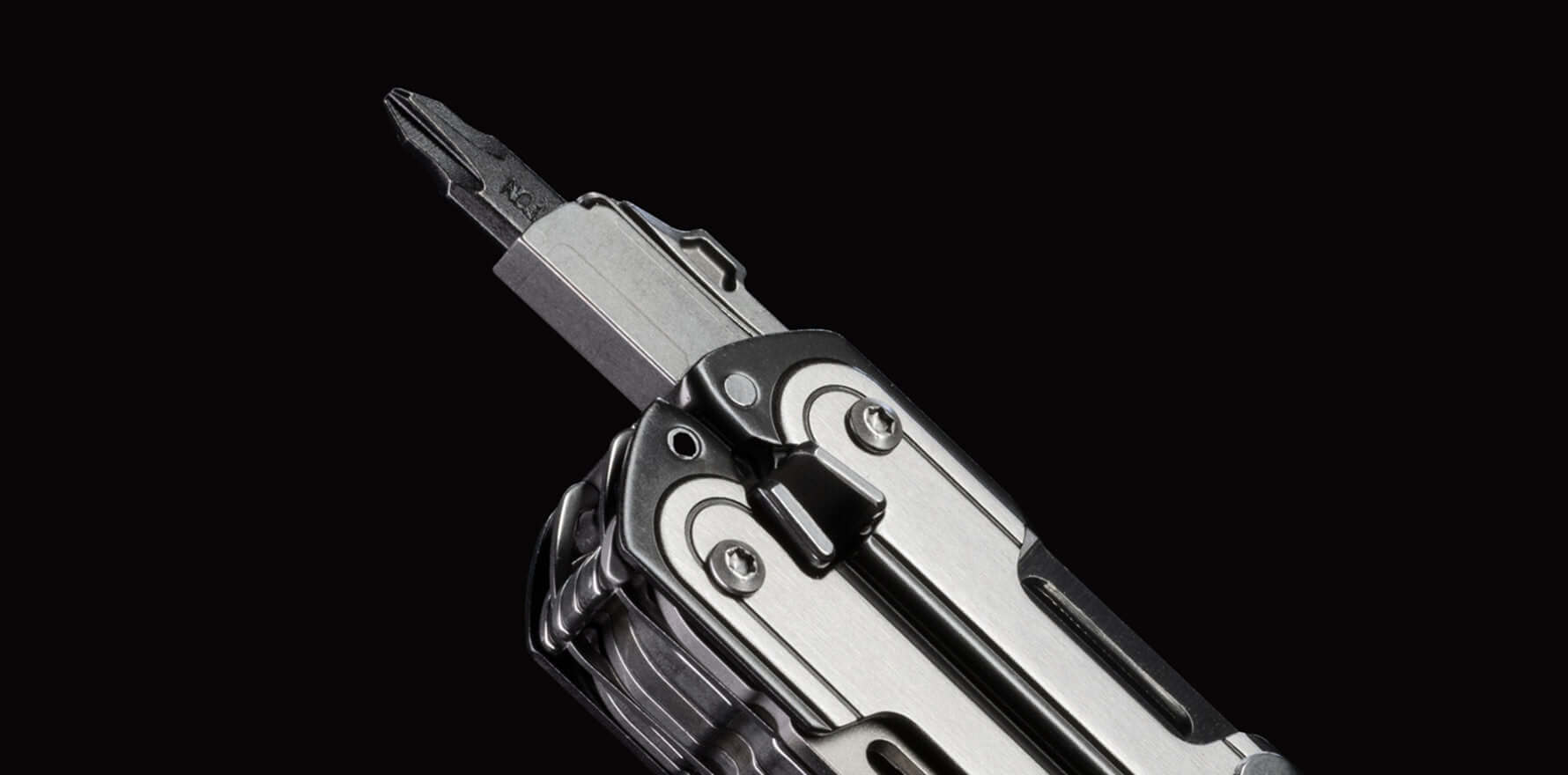 Close-up of the black DLC and stainless steel Leatherman ARC® multi-tool showcasing the bit driver.