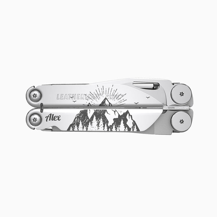 Translation missing: en.A stainless steel Leatherman Curl multitool featuring a detailed engraving of a mountain landscape with radiating lines suggesting a sunrise or sunset behind the mountains. The name “Alex” is engraved on one side