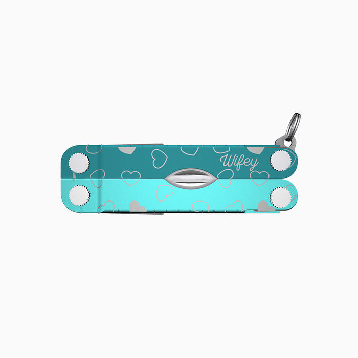 Translation missing: en.A two-tone turquoise Leatherman Micra multitool featuring heart engravings and the word “Wifey” engraved in a script font