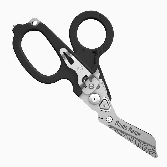 Translation missing: en.A black-handled Leatherman Raptor Rescue tool with floral patterns engraved on the blade. The scissor blade includes the engraved placeholder “Name Name.”