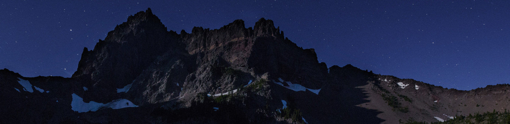Translation missing: en.Breathtaking night view of rugged peaks under a starry sky