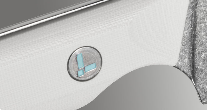 Translation missing: en.Close-up image of the Leatherman Rustle Alpine knife handle, featuring a textured white G10 grip and an embedded circular Leatherman logo in silver with a light blue inlay